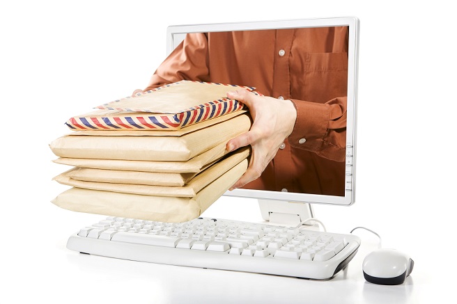 A man is delivering mail packages from inside the computer's screen.