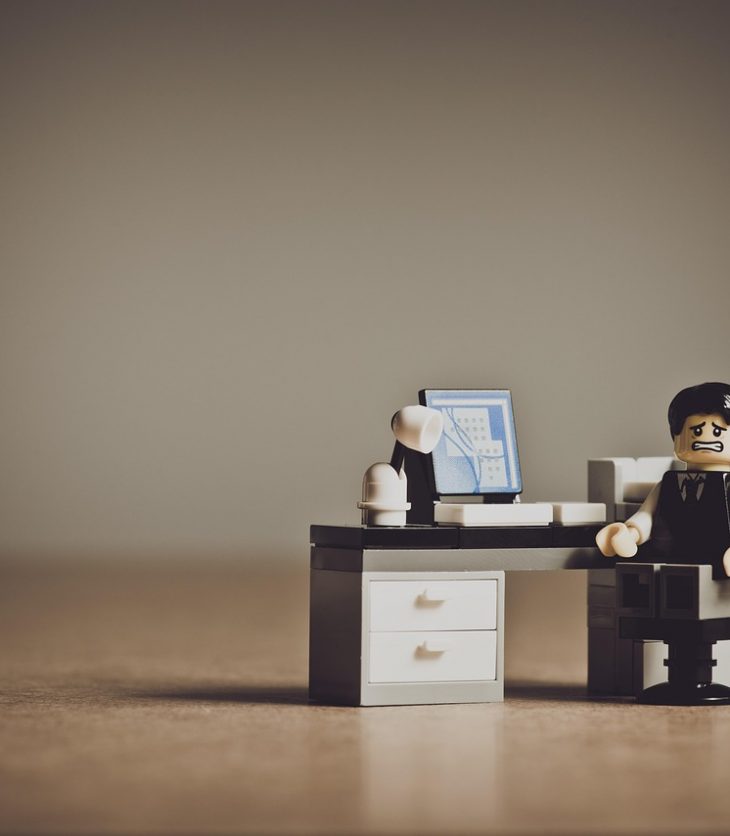 Sad Lego minifg sits at a Lego desk